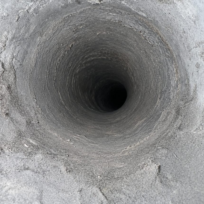 The same air duct after cleaning — restored to clean bare metal