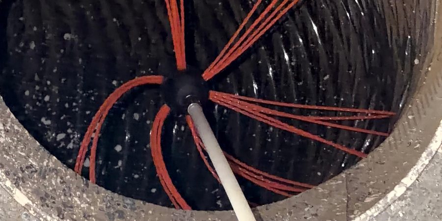 Air duct cleaning in action — rotary brush inside a duct line